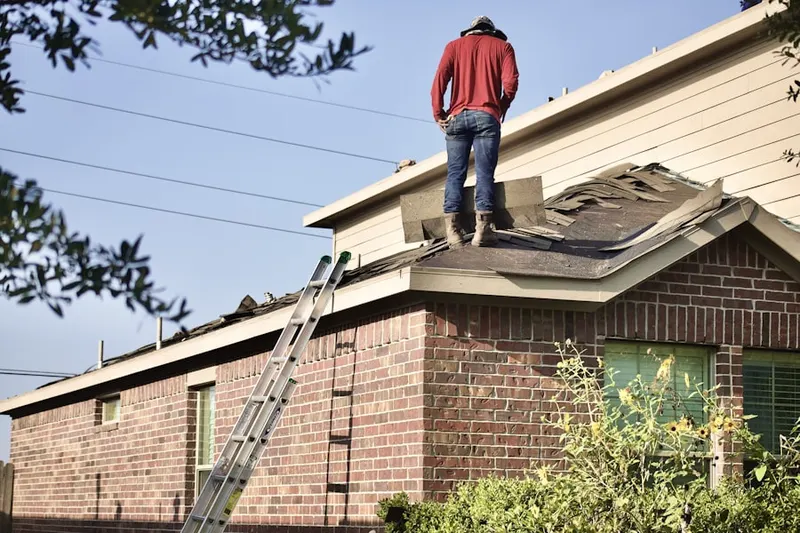 Professional roofer working on a residential roof in Shirley Center